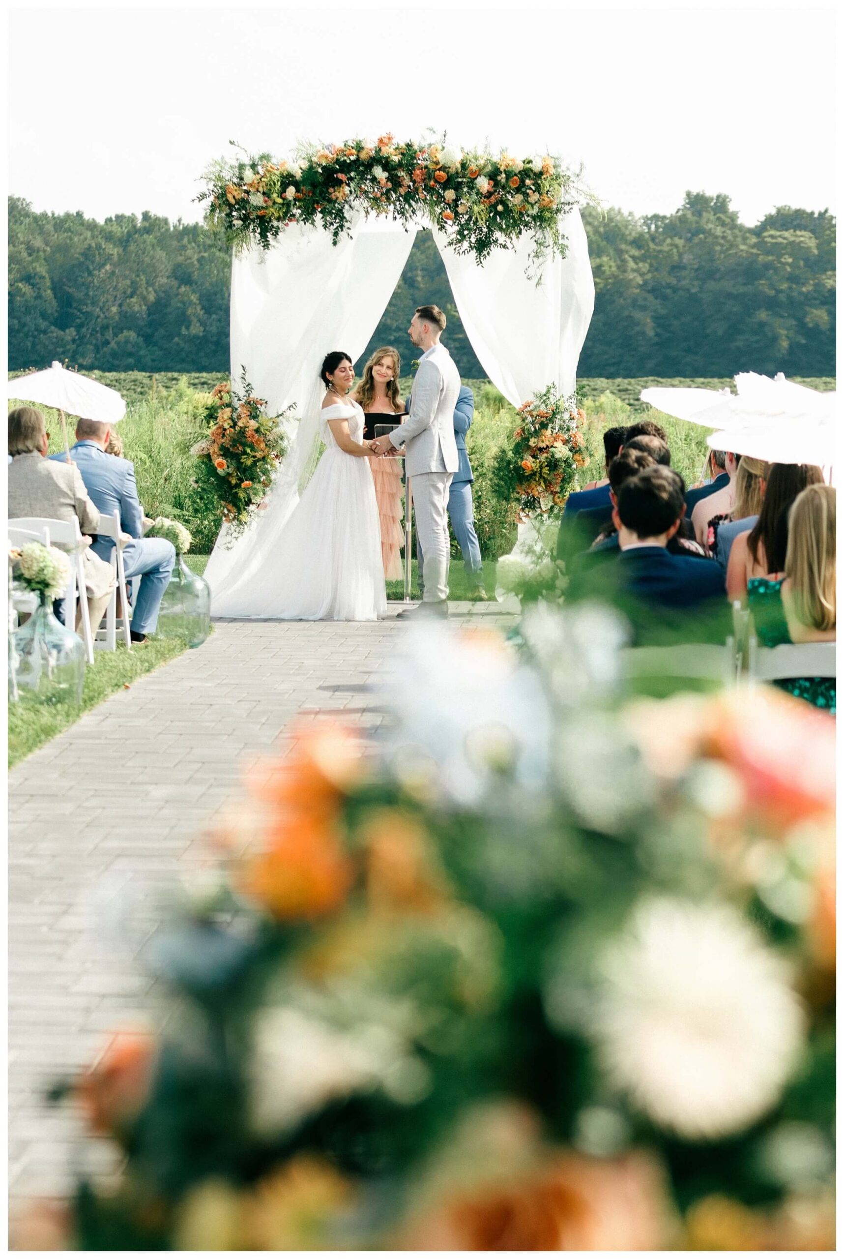 white barn wedding with parasols at etre farms in saint joseph michigan by josh and andrea photography