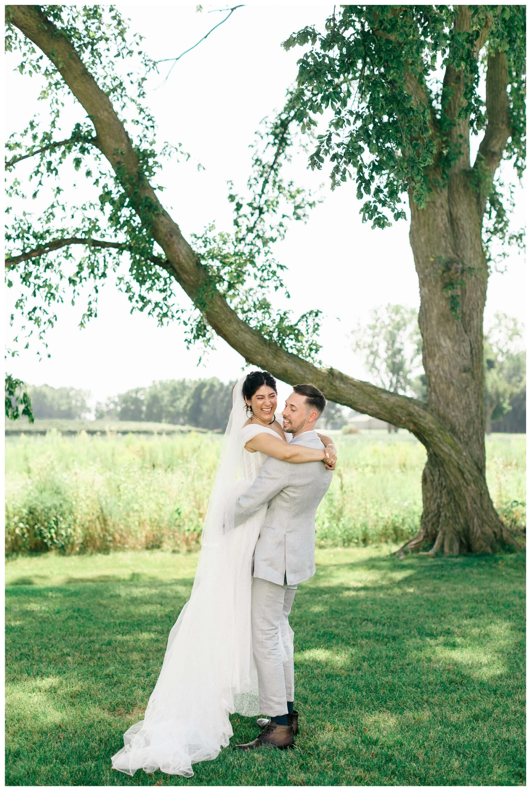 white barn wedding with parasols at etre farms in saint joseph michigan by josh and andrea photography