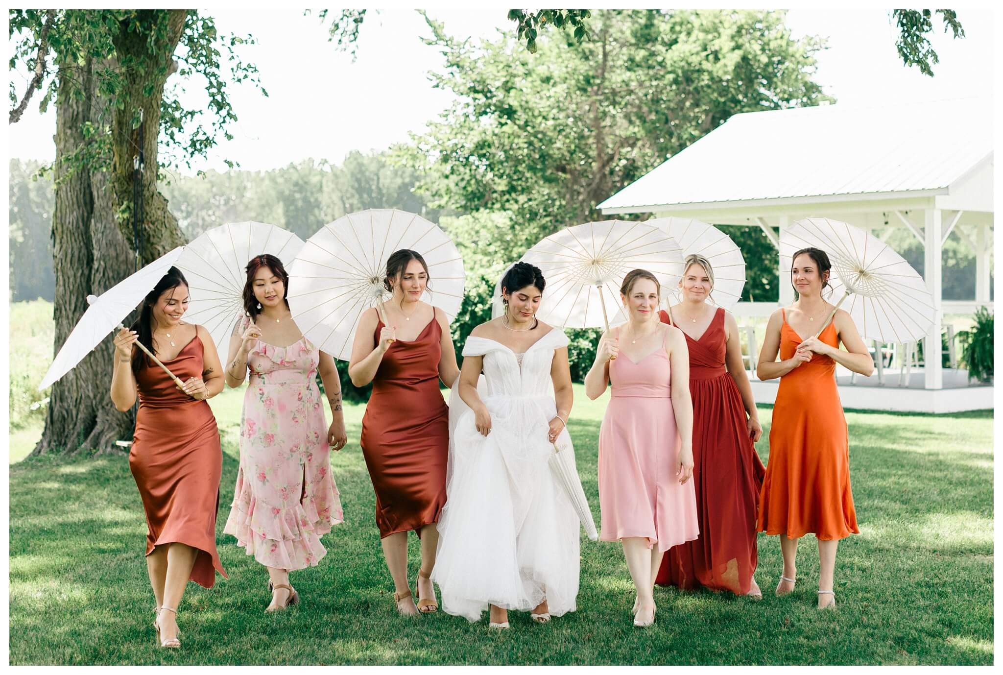 white barn wedding with parasols at etre farms in saint joseph michigan by josh and andrea photography