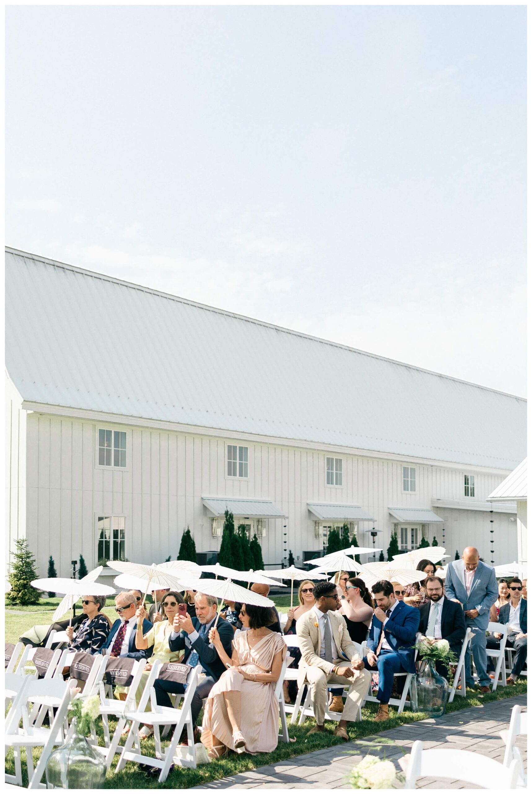 white barn wedding with parasols at etre farms in saint joseph michigan by josh and andrea photography