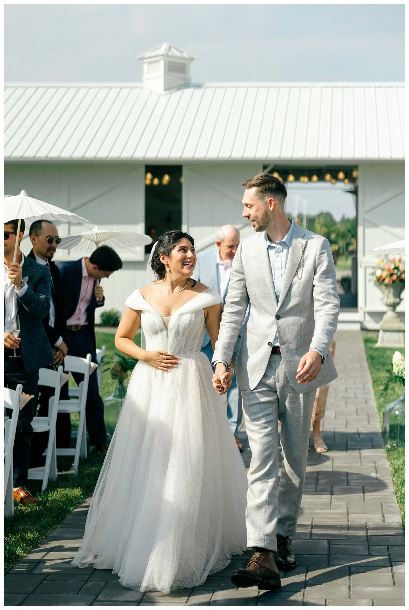 white barn wedding with parasols at etre farms in saint joseph michigan by josh and andrea photography