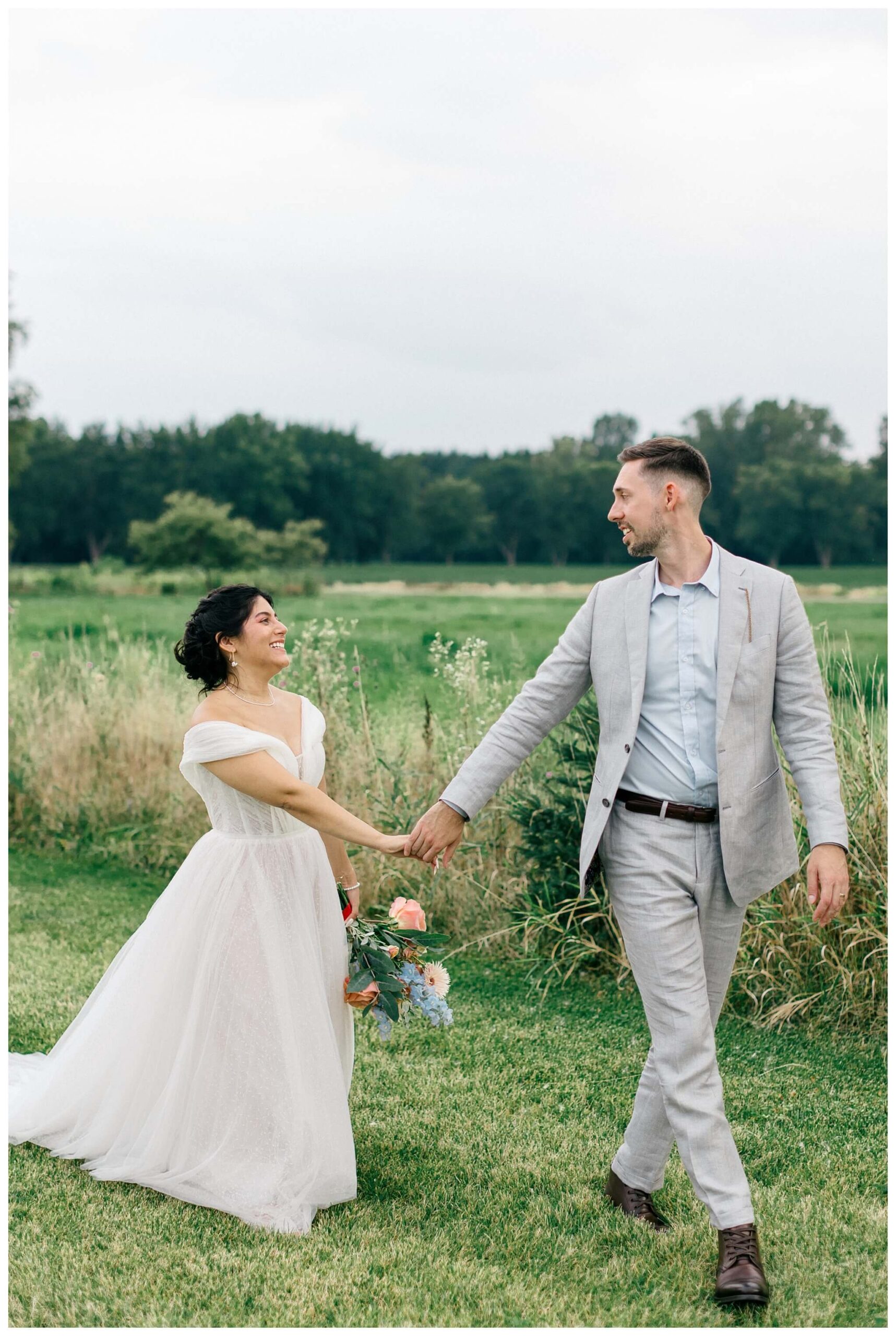 white barn wedding with parasols at etre farms in saint joseph michigan by josh and andrea photography