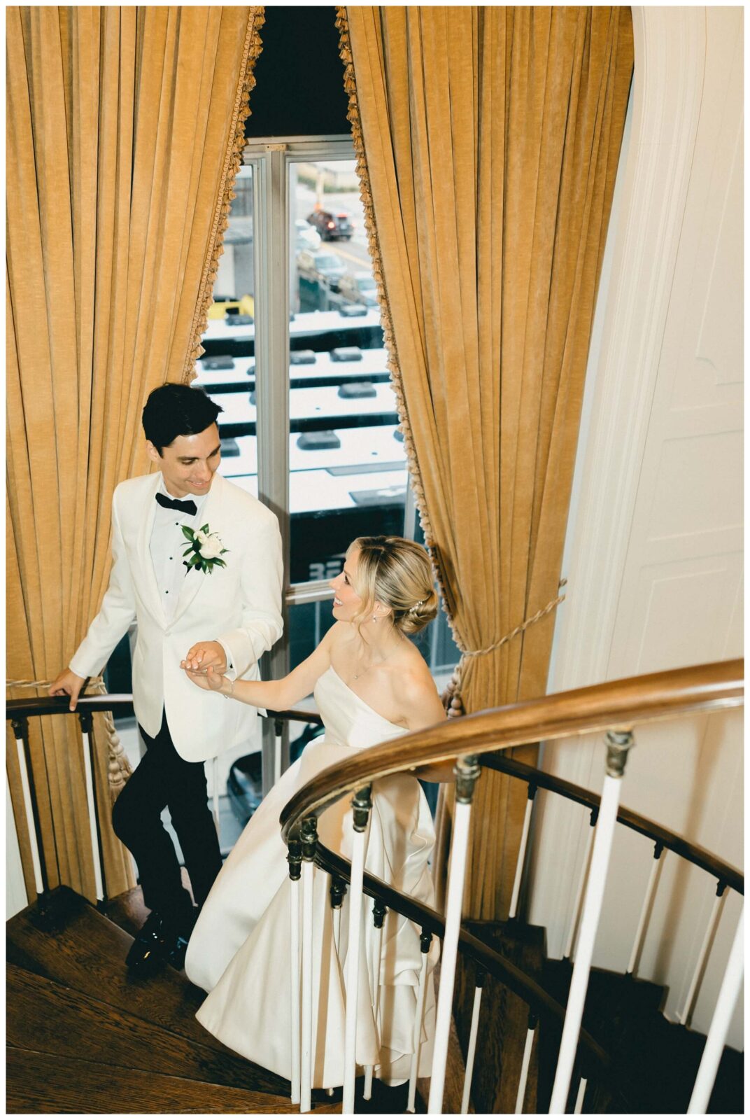Bride and groom walk up staircase at Colony Club