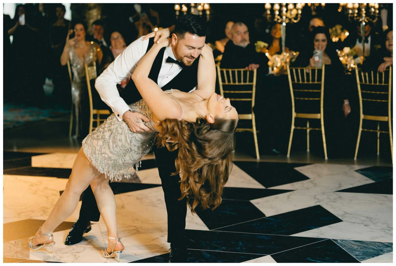 Groom dips bride during first dance at The Drake Hotel wedding reception