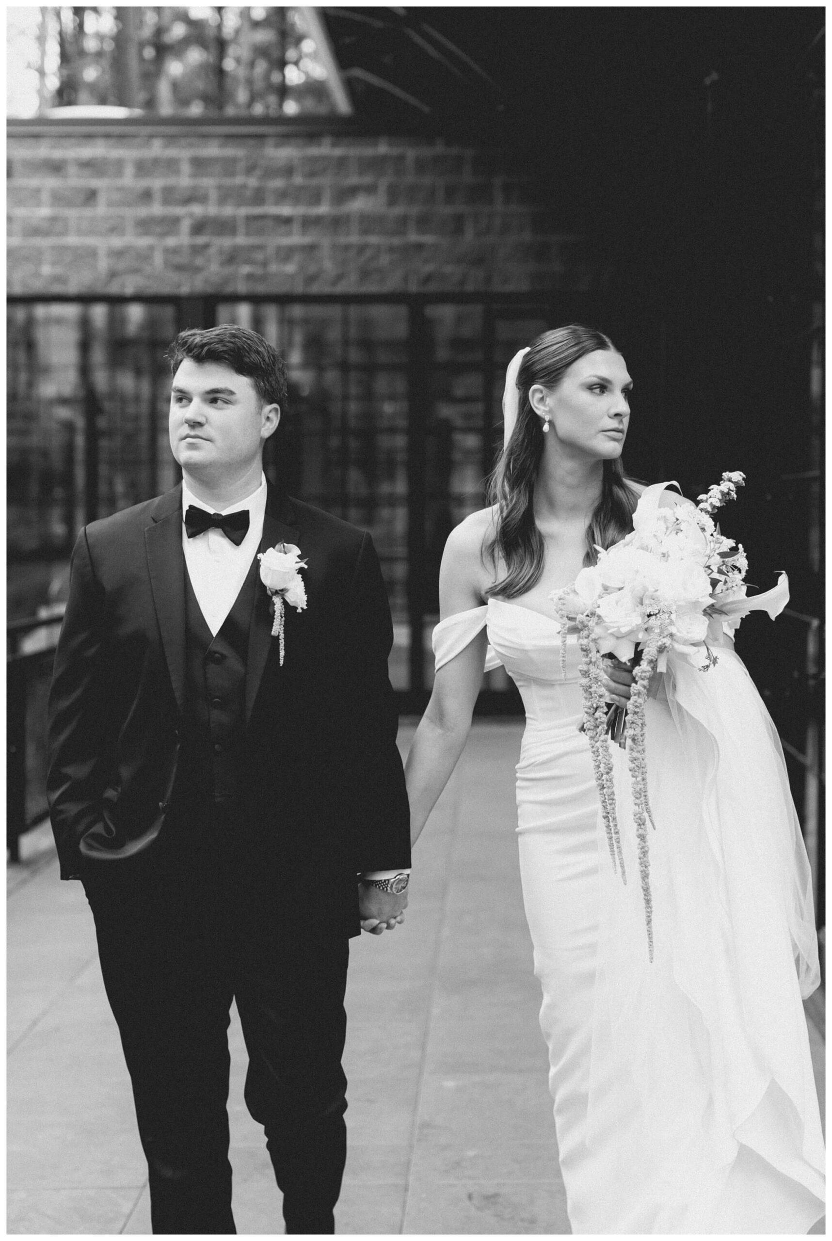 black and photo photo of bride and groom at Shepherd's Hollow on a rainy wedding day photographed by josh and andrea photography 