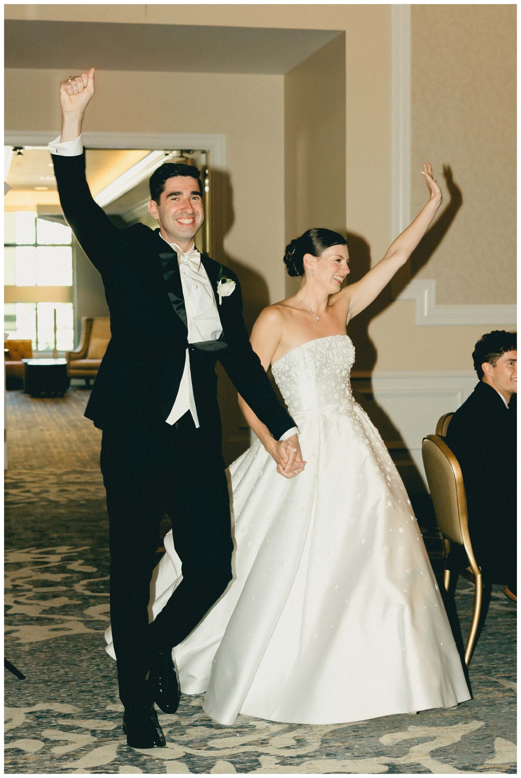 bride and groom enter the reception at the morris inn at Notre dame indiana by josh and andrea photography
