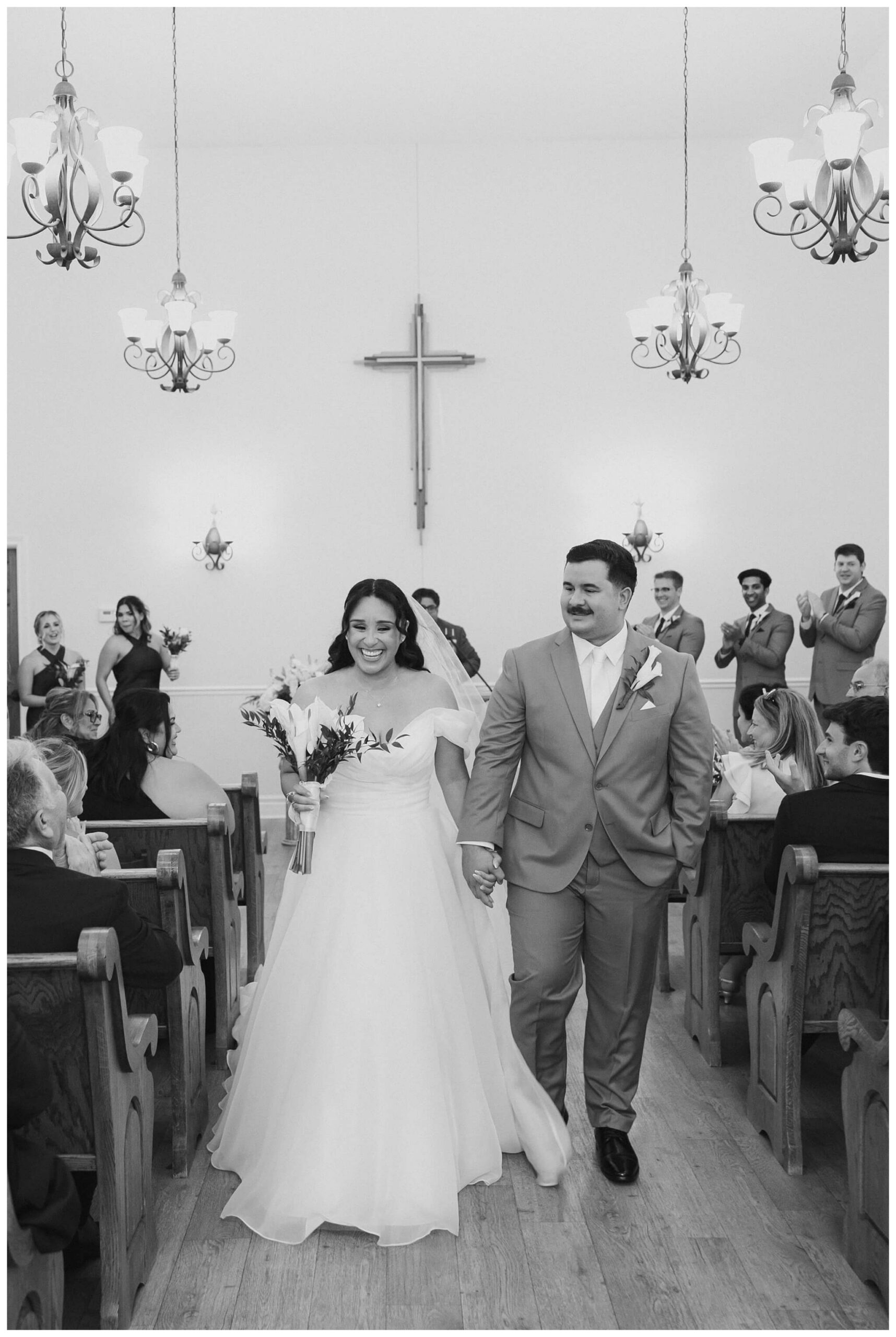 bride and groom walking down the aisle at hope chapel in rochester michigan by josh and andrea photography 