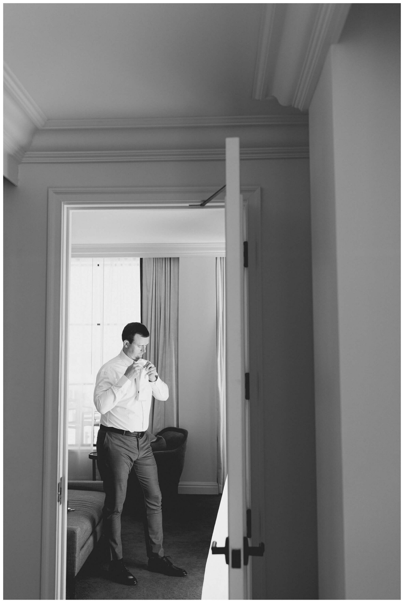 groom getting ready at the Daxton Hotel in Birmingham michigan by josh and andrea photography 