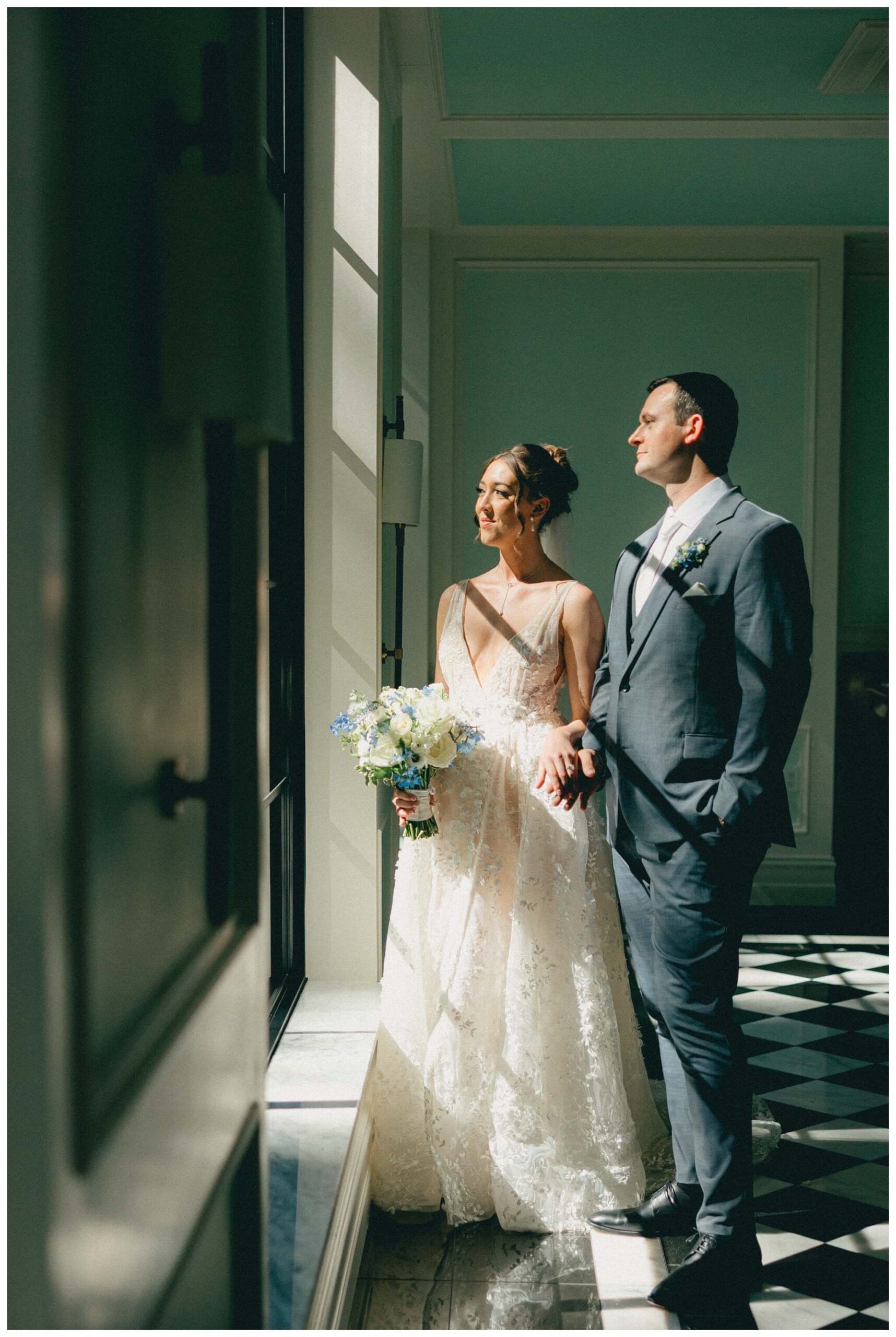 bride and groom in hallway at shepherd's hollow golf club in clarkston michigan by josh and andrea photography 