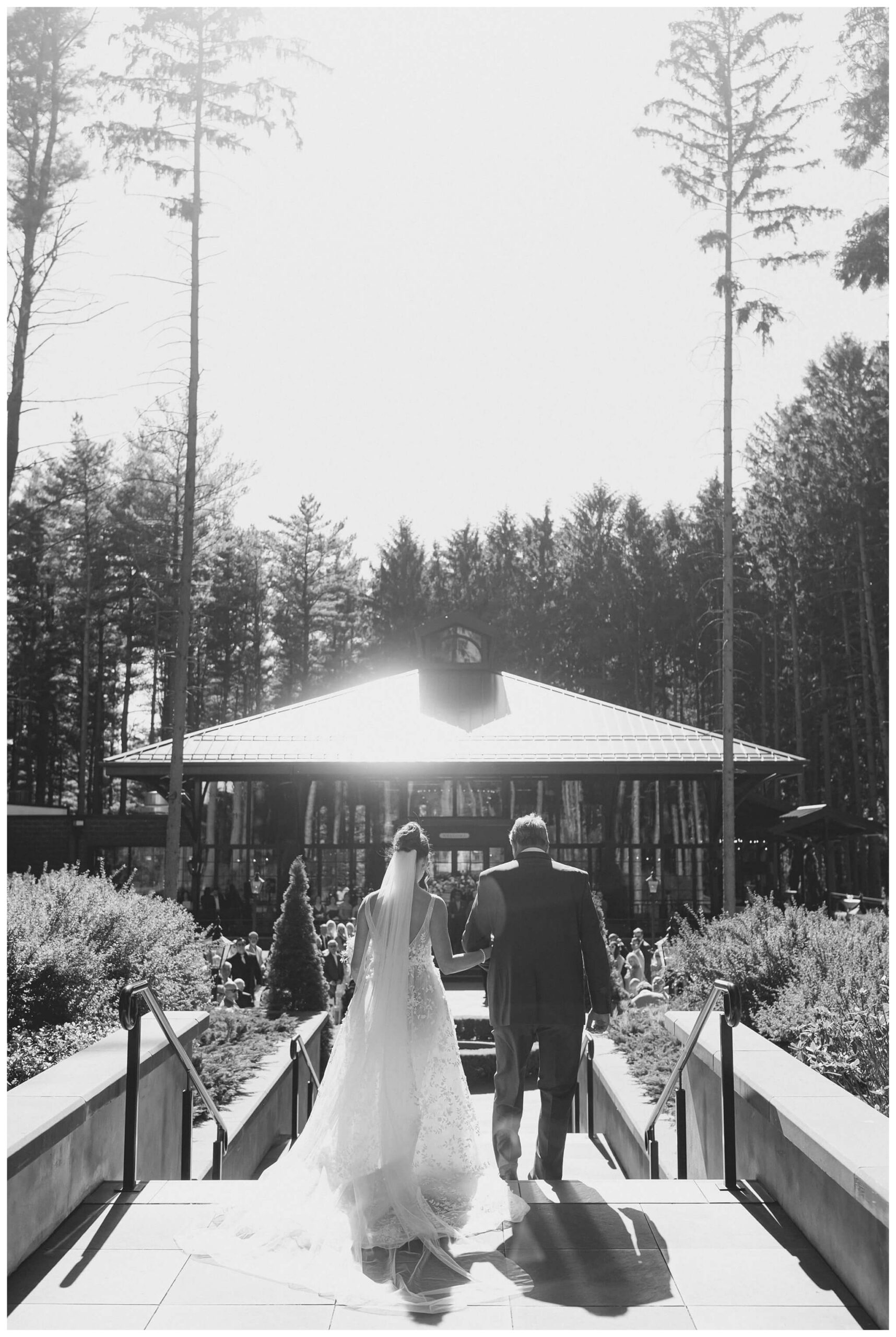 bride and father walking down the aisle for ceremony at shepherd's hollow golf club in clarkston michigan by josh and andrea photography 