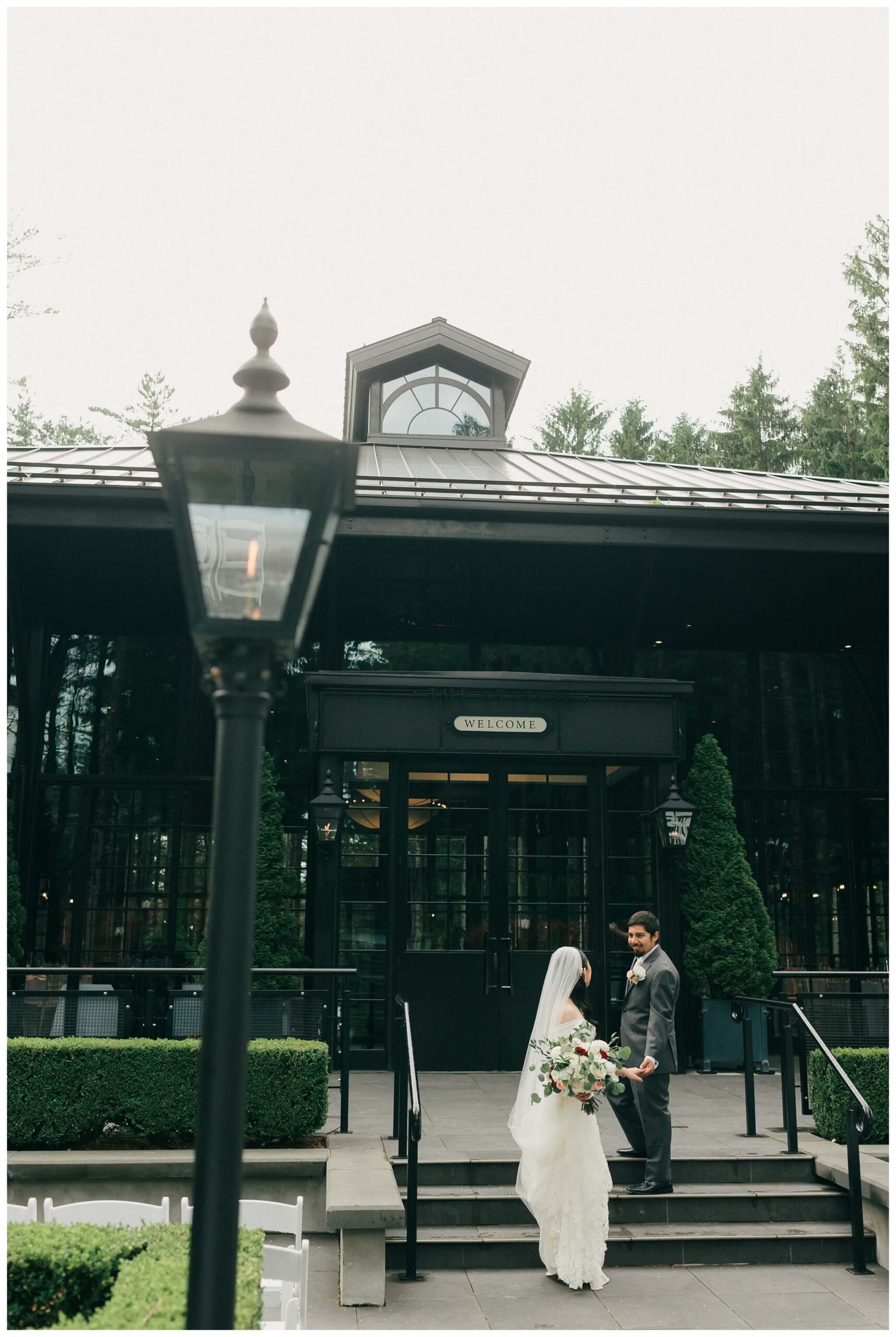 bride and groom in front of Shepherd's hollow golf club near clarkston michigan by josh and andrea photography 