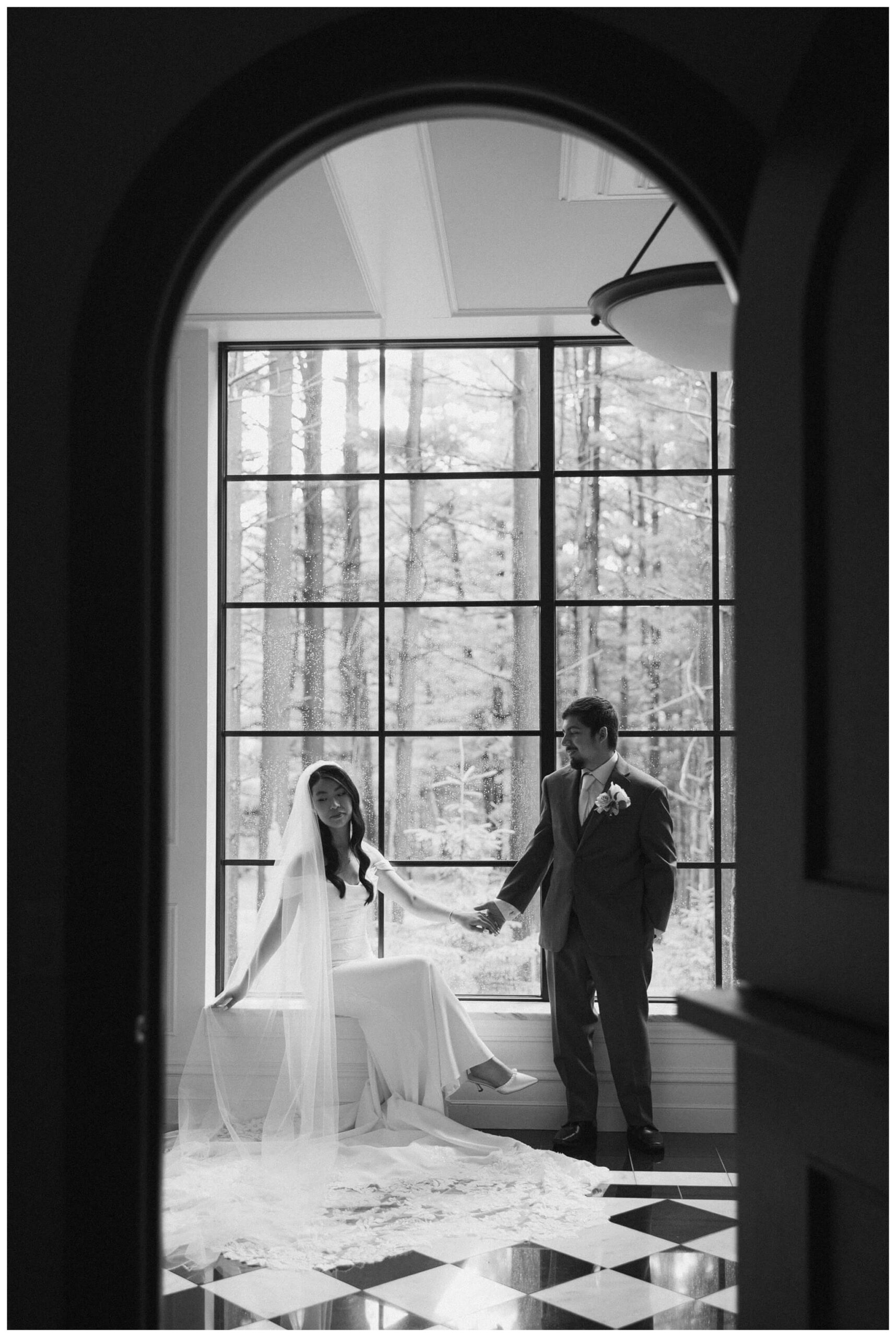 bride and groom in the hallway at Shepherd's hollow golf club near clarkston michigan by josh and andrea photography 