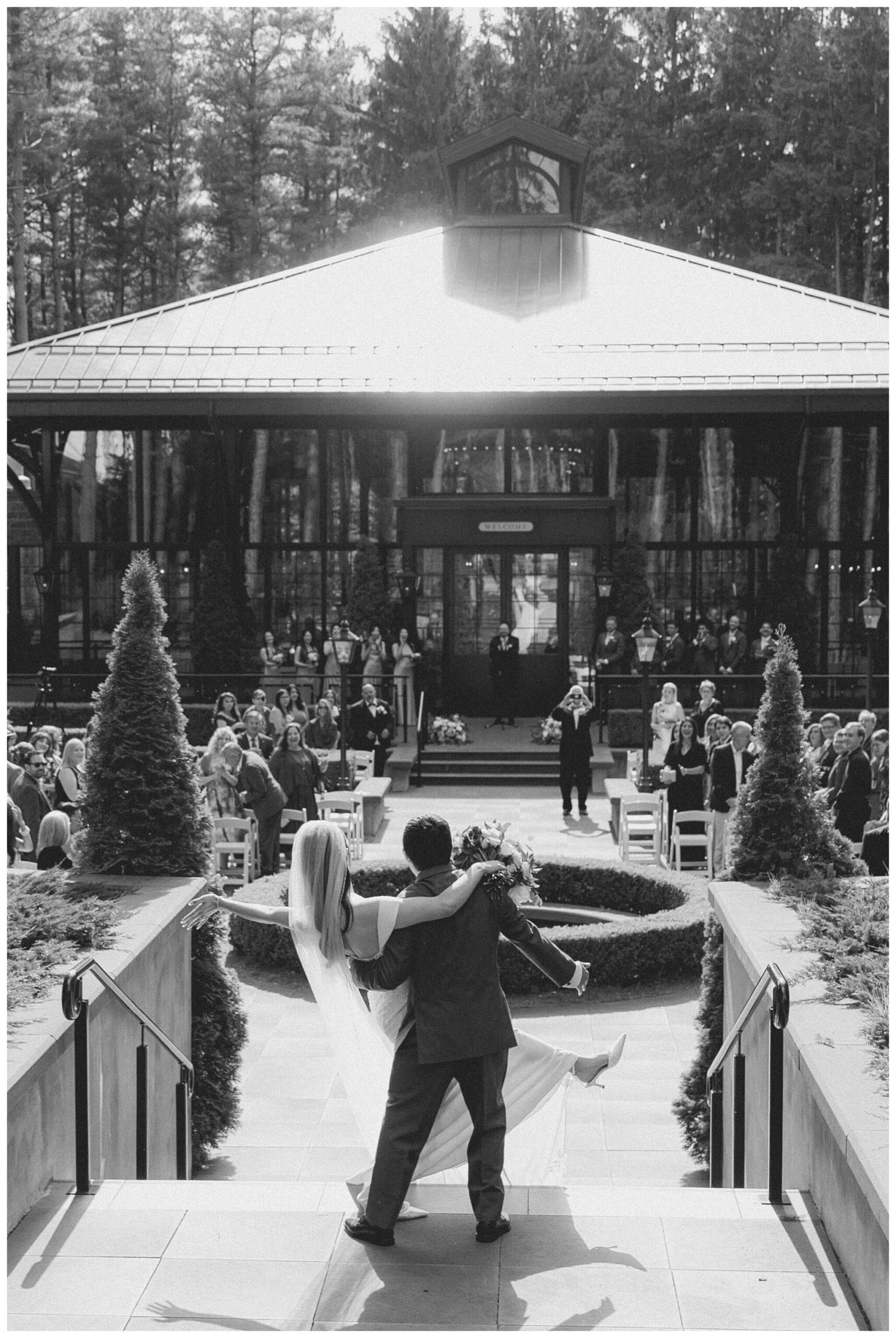bride and groom looking back at the ceremony at Shepherd's hollow golf club near clarkston michigan by josh and andrea photography 