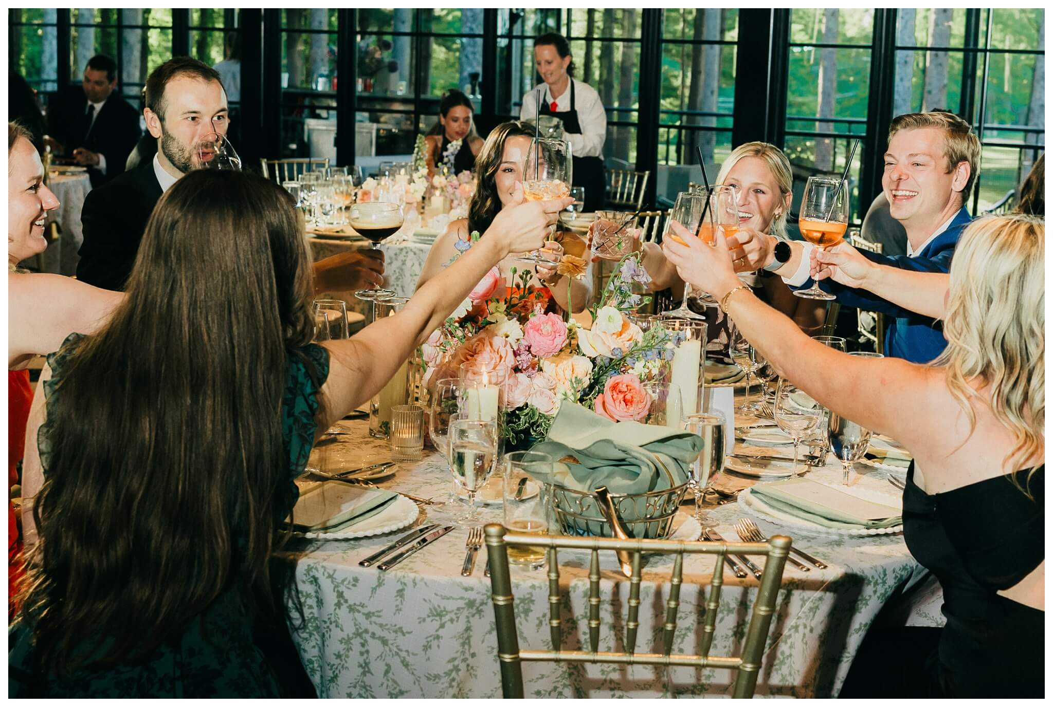 guests cheering and toasting at Shepherd's hollow golf club near clarkston michigan by josh and andrea photography 