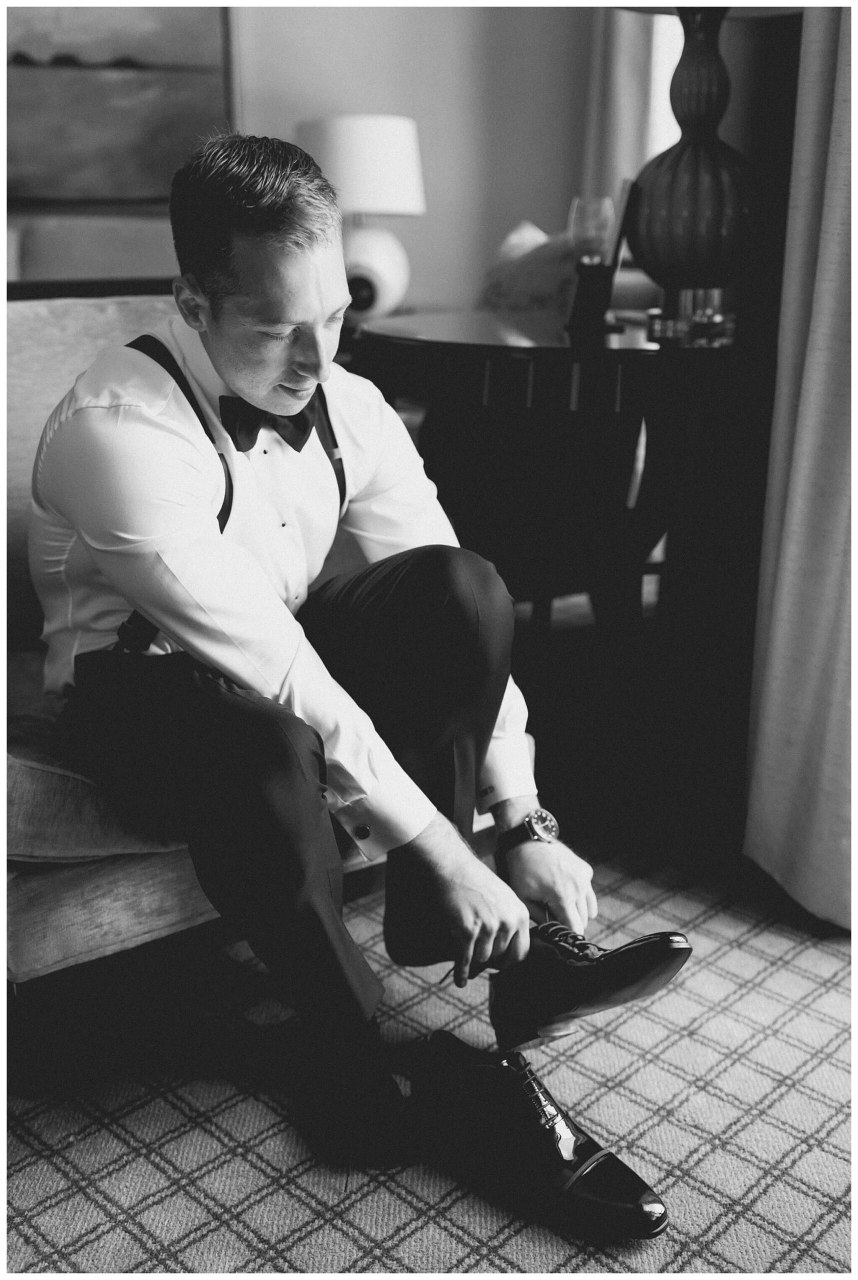 groom getting ready at the townsend hotel by josh and andrea photography 