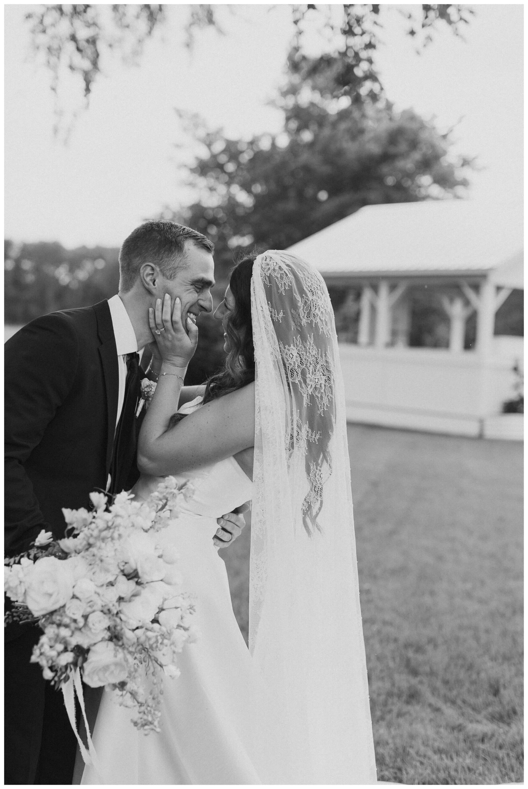 bride and groom smiling at white barn wedding at etre farms by josh and andrea photography 