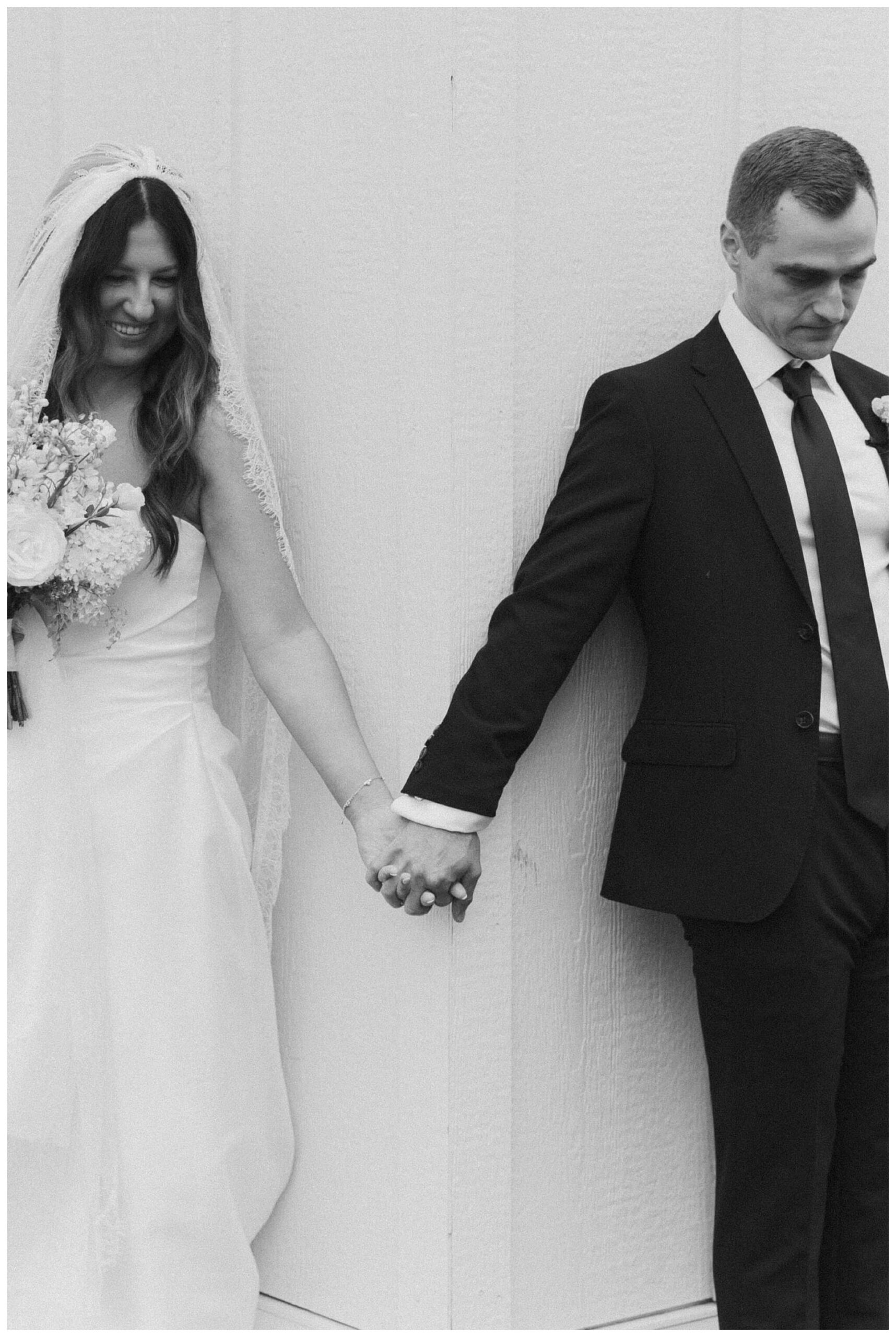 bride and groom share first touch at white barn wedding at etre farms by josh and andrea photography 