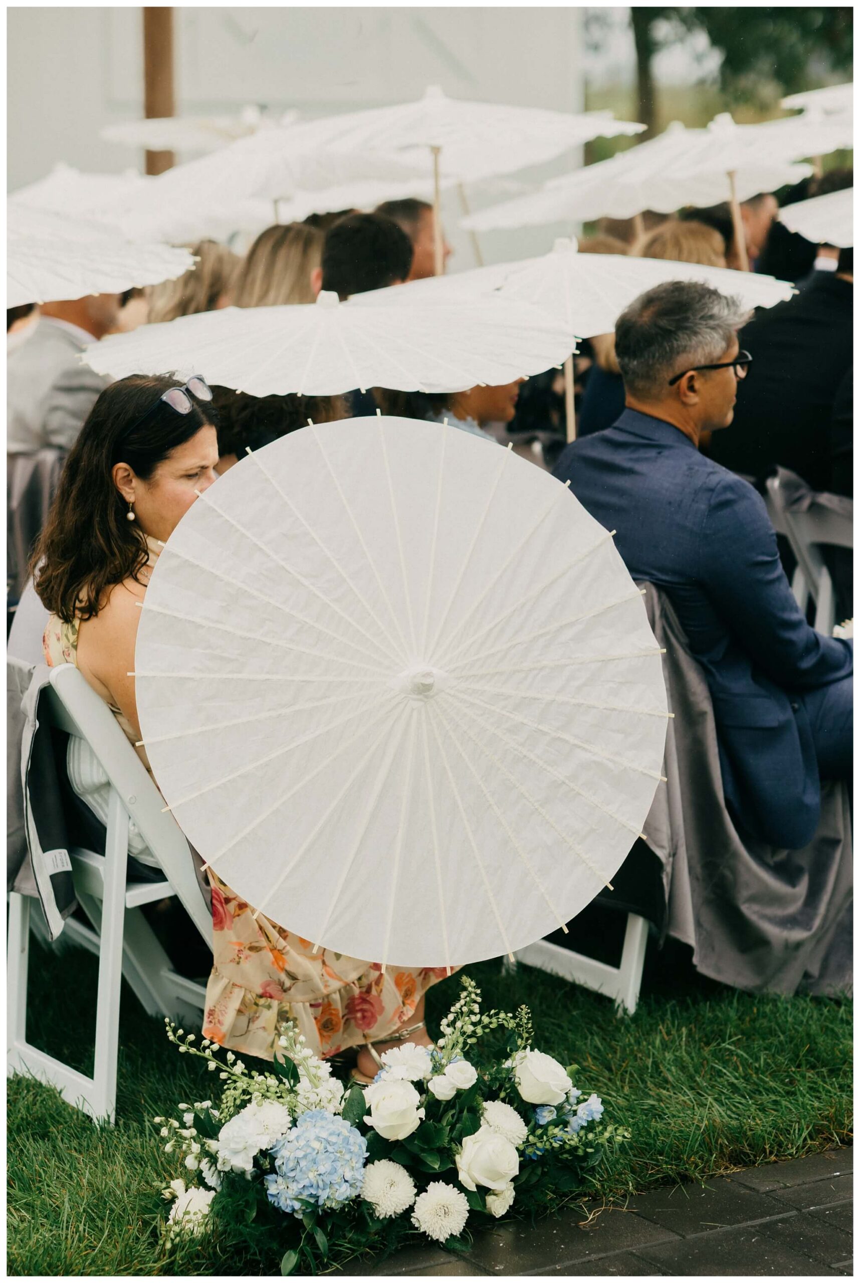 rainy ceremony with parasols at white barn wedding at etre farms by josh and andrea photography 