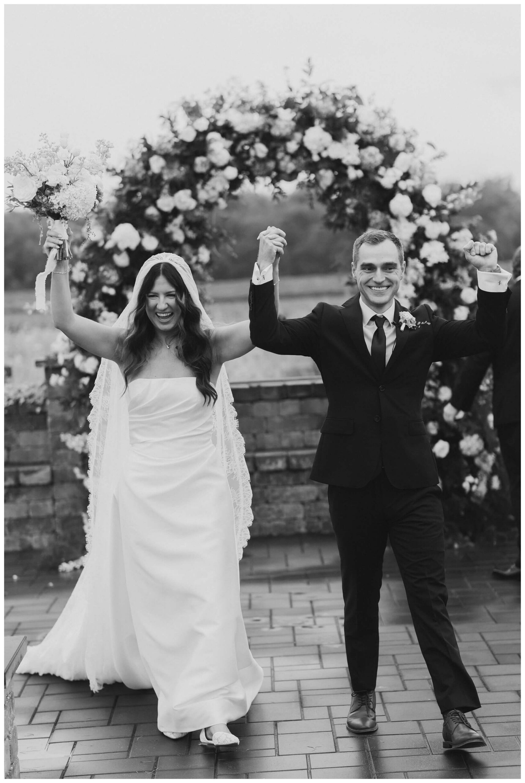 bride and groom celebrate at white barn wedding at etre farms by josh and andrea photography 