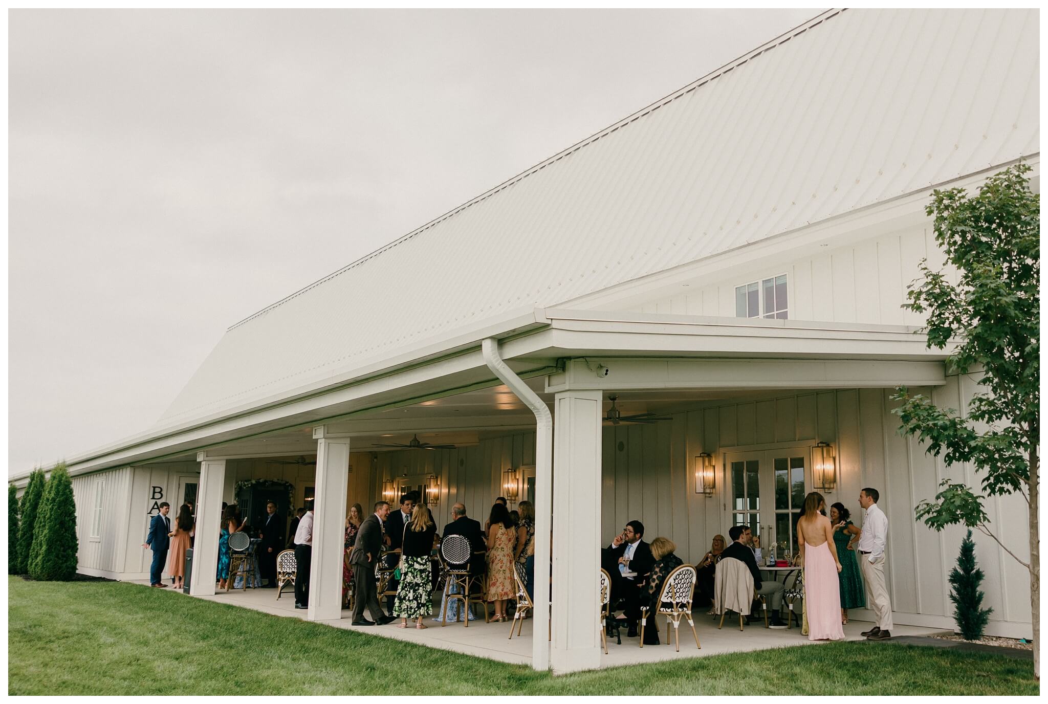 rainy cocktail hour at white barn wedding at etre farms by josh and andrea photography 