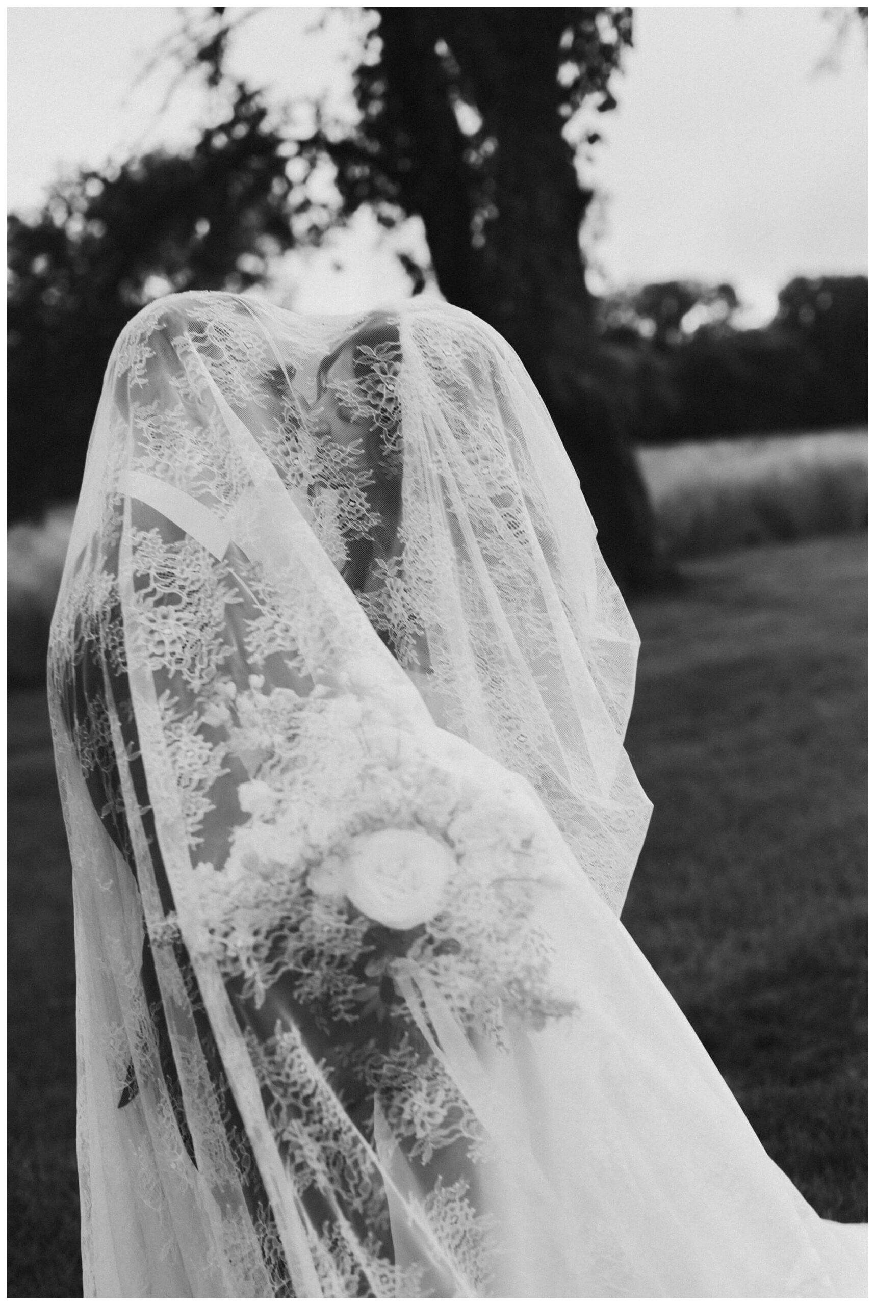 bride and groom portrait under veil at white barn wedding at etre farms by josh and andrea photography 