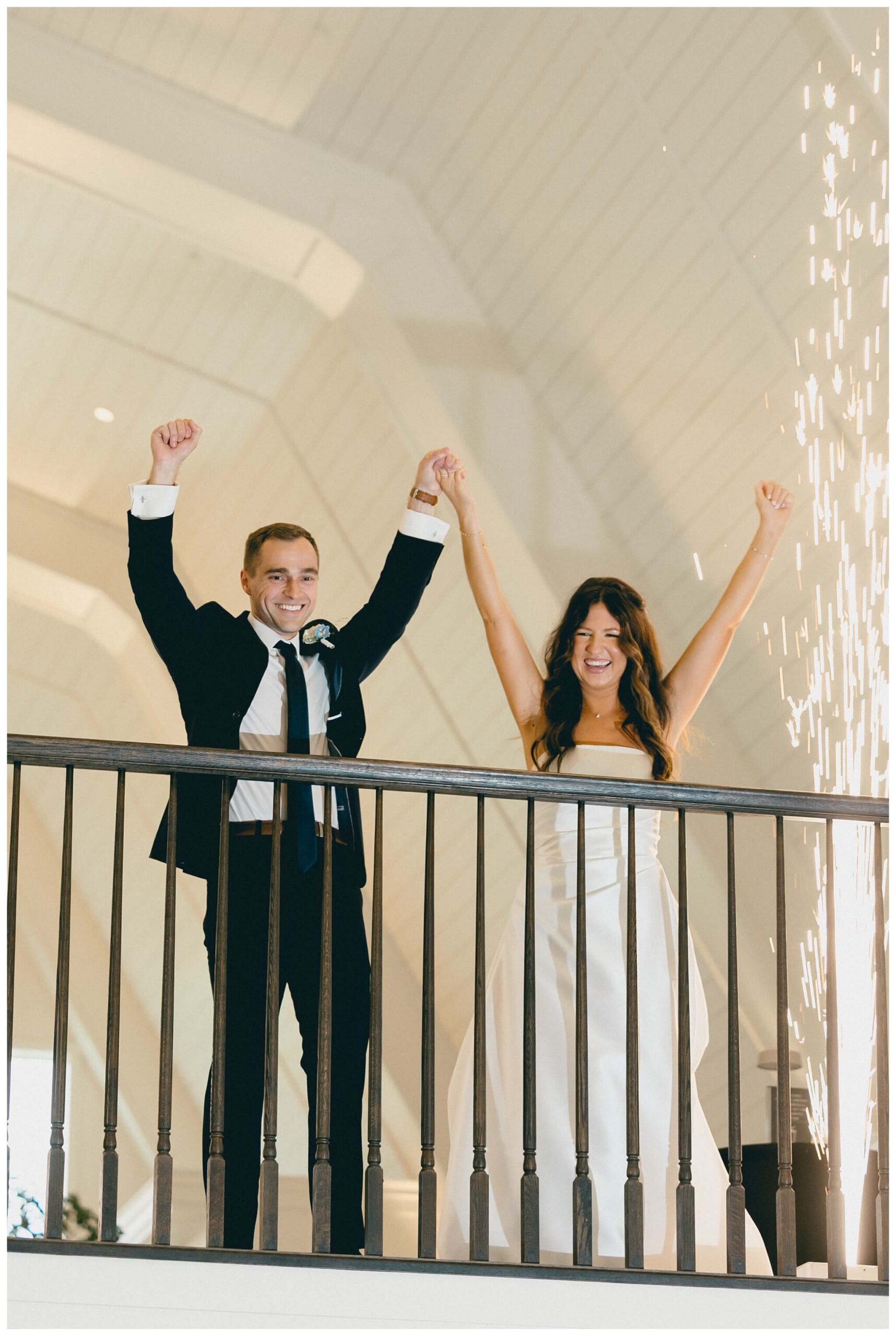 bride and groom celebrate at white barn wedding at etre farms by josh and andrea photography 