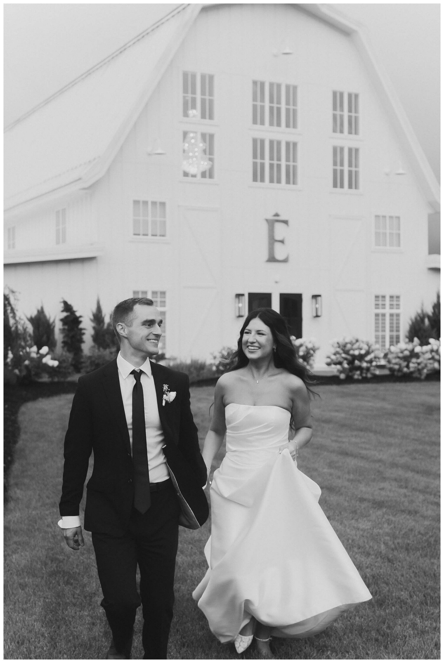 bride and groom stormy portraits at white barn wedding at etre farms by josh and andrea photography 