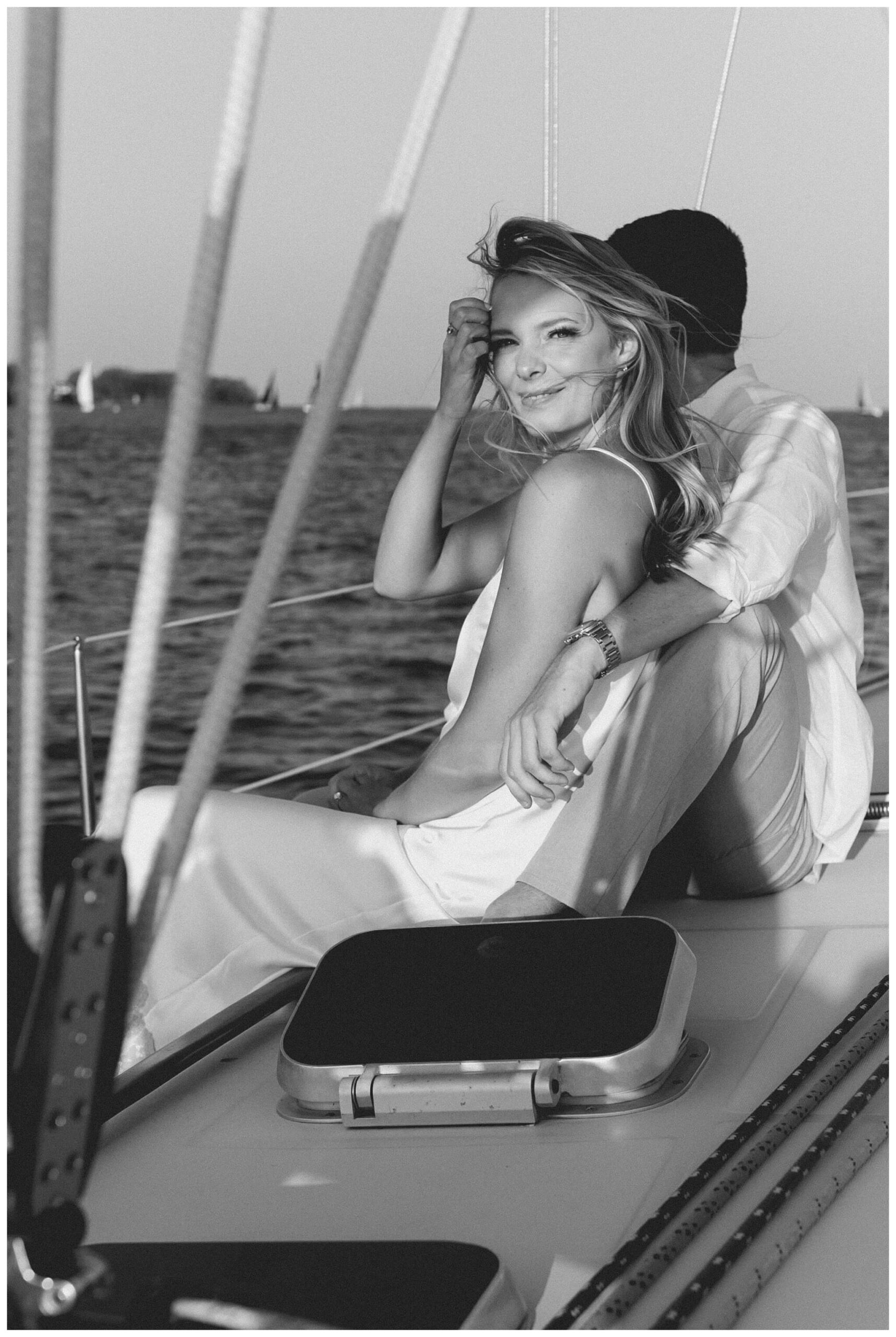 girl looking at camera during sailboat engagement session in detroit by josh and andrea photography 