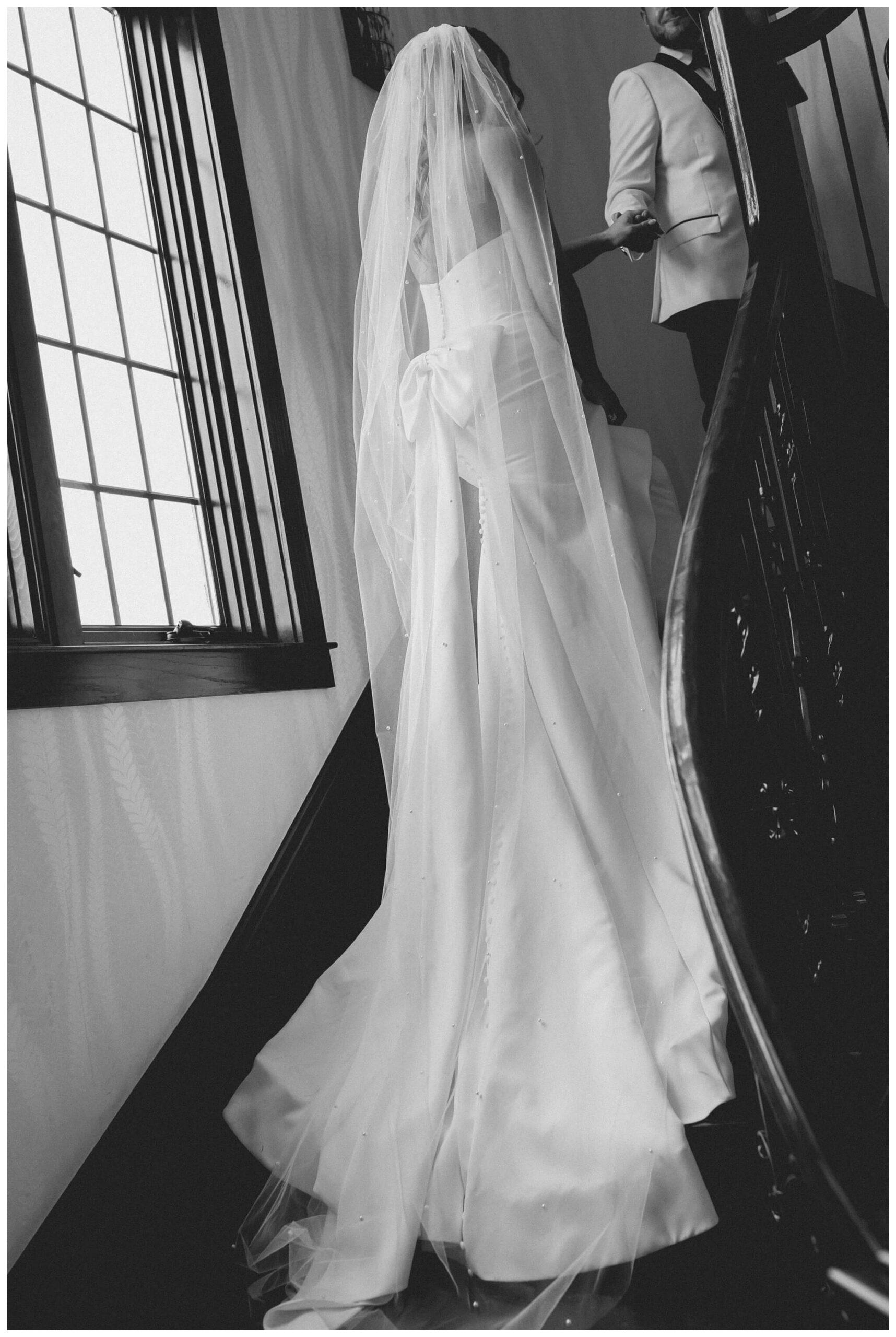 bride and groom on stairs at venue3two wedding by josh and andrea photography