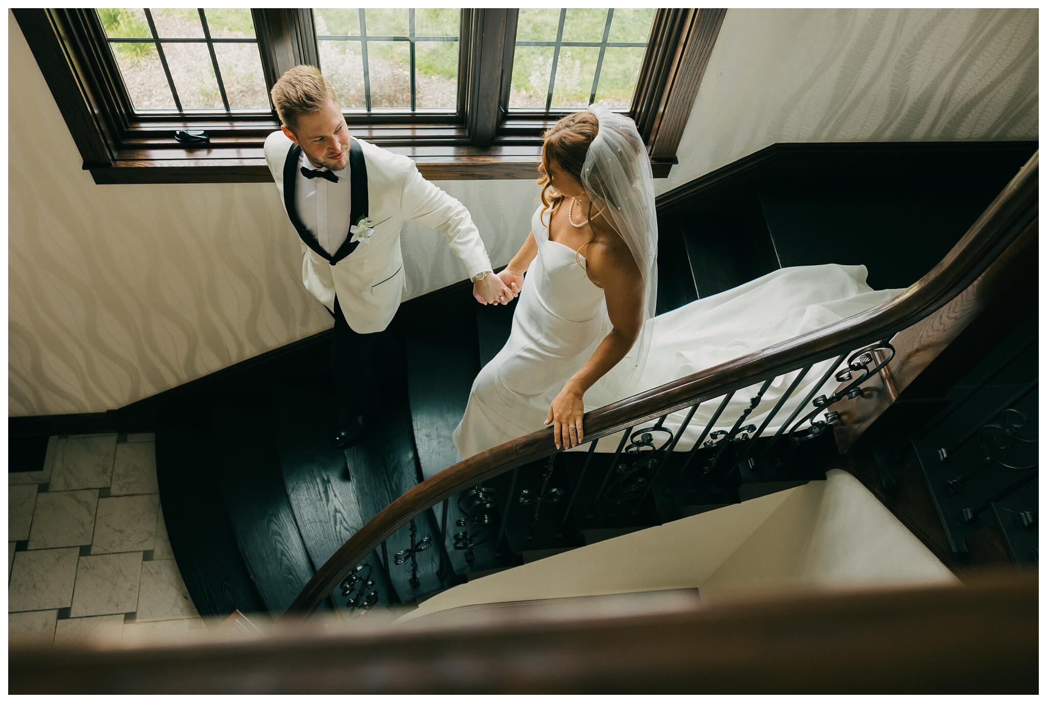 bride and groom on stairs at venue3two wedding by josh and andrea photography